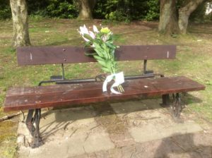 A bouquet laying on a bench for someone to pick up